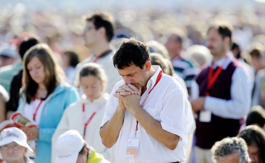 The 25th annual East of the River Revival starts Monday, offering four days of faith-based events for the young and old hoping to reconnect with their religion. In this 2011 file photo, people pray at a Mass with then-Pope Benedict XVI and about 100.000 believers at the airfield in Freiburg, Germany. (AP Photo/Martin Meissner) ** FILE **