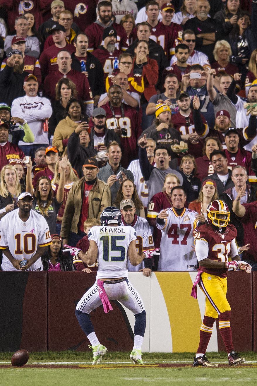 Seattle Seahawks wide receiver Jermaine Kearse (15) celebrates his first quarter touchdown in front of the Washington Redskins fans after beating Washington Redskins strong safety Brandon Meriweather (31) at FedExField, Landover, Md., Oct. 6, 2014. (Preston Keres/Special for The Washington Times)