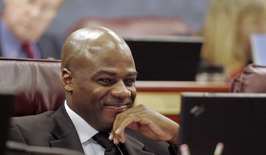 In this May 19, 2005, file photo, Sen. Kelvin Atkinson, D-Las Vegas, listens to testimony during a Government Affairs committee meeting at the Nevada State Legislature in Carson City, Nev. Atkinson says he proposed to his partner immediately after hearing that an appeals court had overturned the state&#39;s ban on same-sex marriage. (AP Photo/Nevada Appeal, Brad Horn, File)