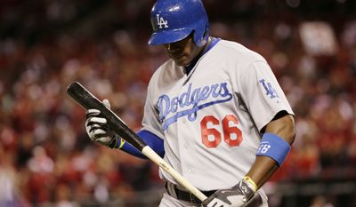 Los Angeles Dodgers right fielder Yasiel Puig walks back to the dugout after striking out in the eighth inning of Game 3 of baseball&#39;s NL Division Series against the St. Louis Cardinals, Monday, Oct. 6, 2014, in St. Louis. (AP Photo/Charles Rex Arbogast)