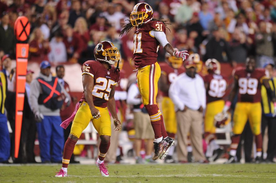 Washington Redskins strong safety Brandon Meriweather (31) celebrates his second quarter sack with free safety Ryan Clark (25) against the Seattle Seahawks at FedExField, Landover, Md., Oct. 6, 2014. (Preston Keres/Special for The Washington Times)