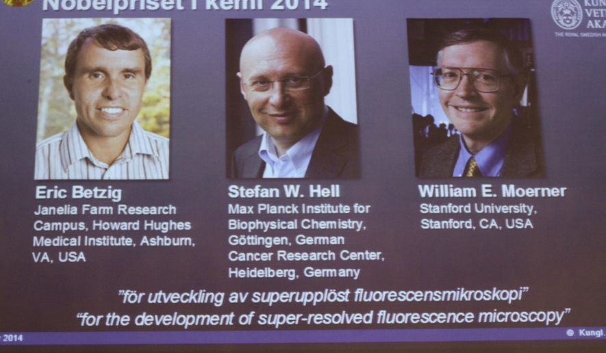 Images of the three winners of the 2014 Nobel Prize for Chemistry Americans Eric Betzig, left, and William Moerner, right, and German scientist Stefan Hell, are projected on a screen at the Royal Swedish Academy of Sciences in Stockholm on Wednesday Oct. 8 2014 . (AP Photo/Bertil Ericson) SWEDEN OUT