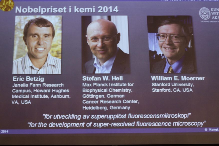 Images of the three winners of the 2014 Nobel Prize for Chemistry Americans Eric Betzig, left, and William Moerner, right, and German scientist Stefan Hell, are projected on a screen at the Royal Swedish Academy of Sciences in Stockholm on Wednesday Oct. 8 2014 . (AP Photo/Bertil Ericson) SWEDEN OUT