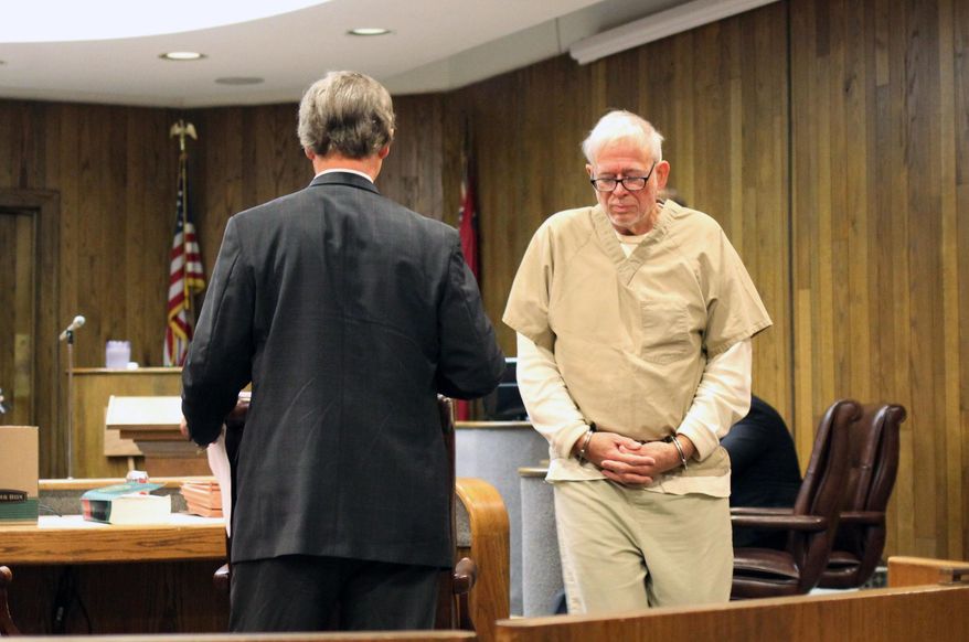 Dr. Arnold Smith, wearing shackles and a tan county jail jumpsuit, arrives in the courtroom at the Leflore County Courthouse Wednesday, Oct. 8, 2014 in Greenwood, Miss., for a hearing on his mental competency. Judge Breland Hilburn ruled that Smith, a Greenwood oncologist and the alleged instigator of a botched murder-for-hire plot to kill attorney Lee Abraham, was mentally unfit for trial and ordered proceedings begun to commit Smith to a mental institution. (AP Photo/The Greenwood Commonwealth, Bryn Stole)