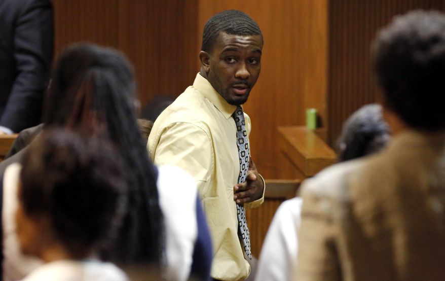 Desmonte Leonard points to family members as he leave the courtroom after a jury found him guilty of capital murder, Tuesday, Oct. 7, 2014, in Opelika, Ala., in the killing two former Auburn University football players and a third man. (AP Photo/Opelika-Auburn News, Todd J. Van Emst)