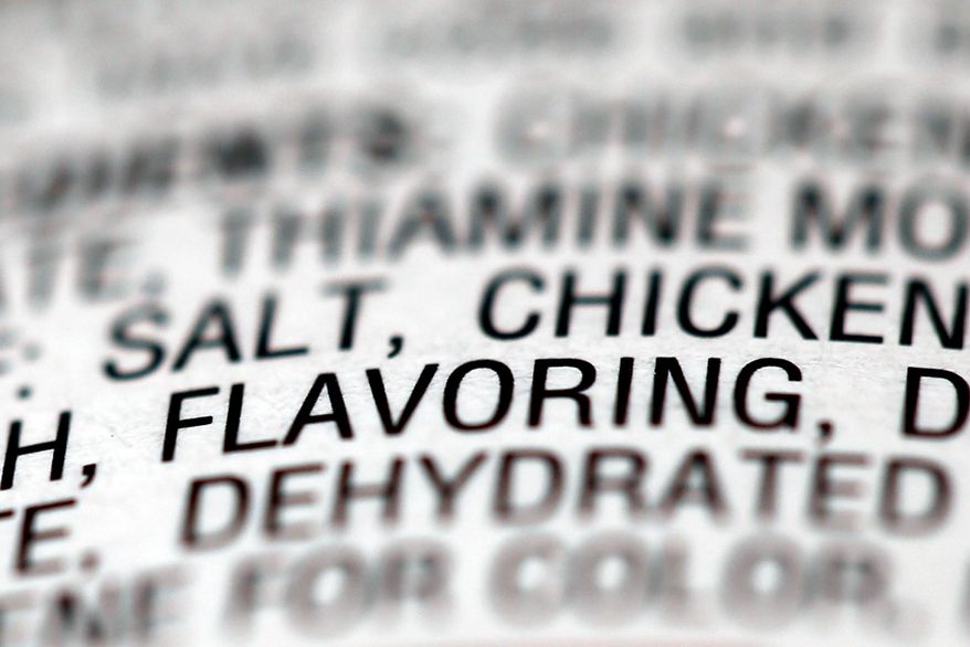 This Sept. 26, 2014 photo shows the ingredients label on a can of Campbell's soup, in Philadelphia. “Artificial and natural flavors” have become ubiquitous terms on food labels, helping create vivid tastes that would otherwise be lost in mass production. As the science behind them advances, however, some are calling for greater transparency about their safety and ingredients. (AP Photo/Matt Rourke)