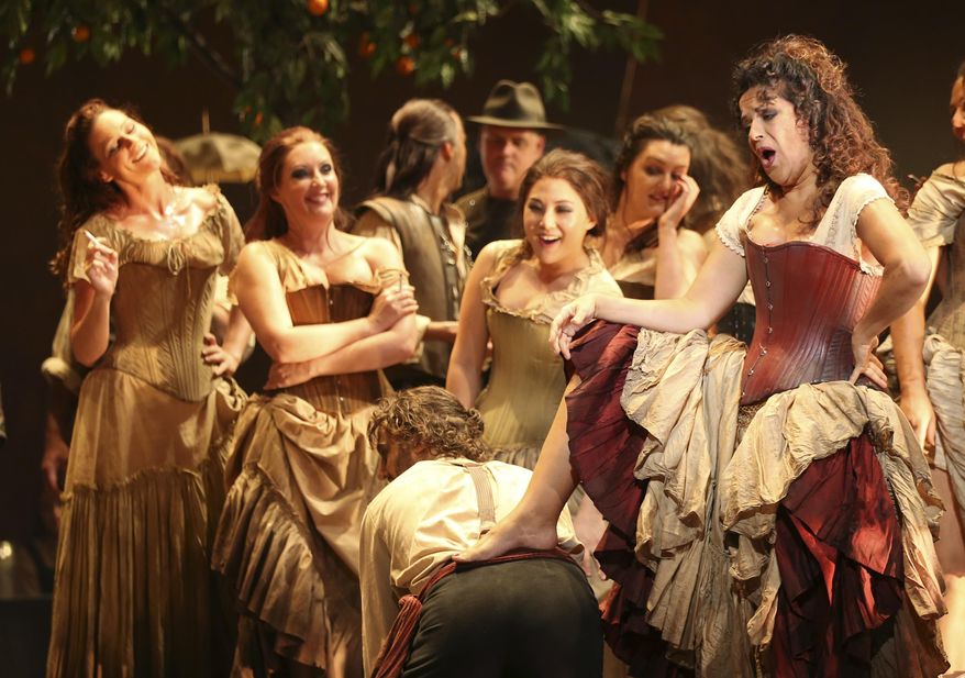 FILE - In this Jan. 31, 2014 file photo, Nancy Fabiola Herrera, right, playing Carmen, performs on stage during the final dress rehearsal of "Carmen" at the Opera House in Sydney, Australia. An Australian opera company is being criticized for banning as part of a sponsorship deal performances of "Carmen" for two years because the 140-year-old French opera depicts smoking. West Australian Opera had been considering a 2015 staging of the popular opera about a Spanish gypsy named Carmen who works in a cigar factory. The ban lasts the duration of a 400,000 Australian dollar ($355,000) sponsorship deal with a state government health promotion agency, Healthway. The deal begins in March and was revealed in the media on Wednesday, Oct. 8. (AP Photo/Rob Griffith, File)