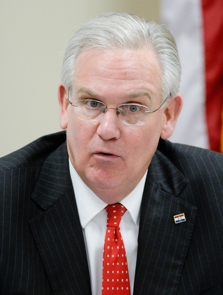 FILE - This Thursday, July 31, 2014 file photo, shows Gov. Jay Nixon speaking during a roundtable discussion about how the new community mental liaisons are improving health and safety in northwest Missouri at Family Guidance Center in St. Joseph, Mo. County health departments across Missouri are asking Nixon to release $3.3 million designated for public health projects that he withheld from the state budget. (AP Photo/The St. Joseph News-Press, Sait Serkan Gurbuz, File)