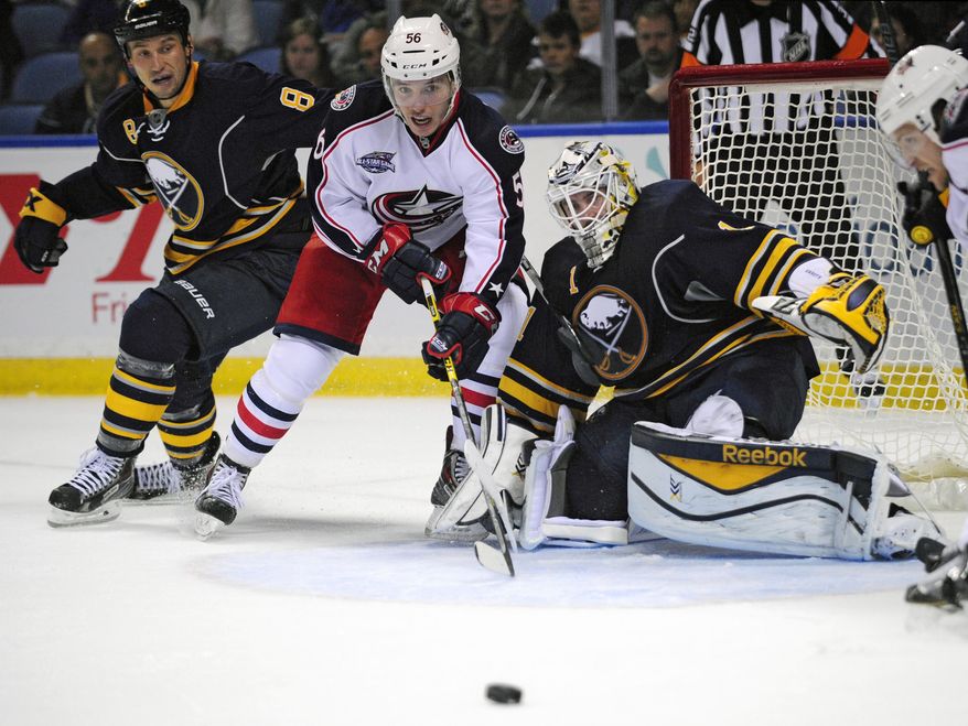 Buffalo Sabres center Cody McCormick (8) and goaltender Jhonas Enroth (1) of Sweden, watch an incoming shot with Columbus Blue Jackets center Marko Dano (56), of Austria, during the second period of an NHL hockey game season opener, Thursday, Oct., 9, 2014, in Buffalo, N.Y. (AP Photo/Gary Wiepert)