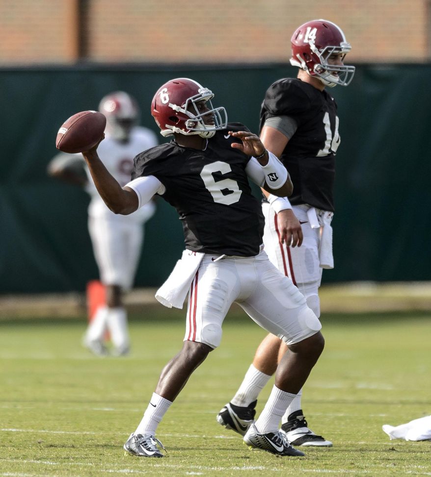 Alabama quarterback Blake Sims (6) works through drills during Alabama football practice, Wednesday, Oct. 8, 2014, at the Thomas-Drew Practice Facility in Tuscaloosa, Ala. Alabama quarterback Jacob Coker (14) is in the background. (AP Photo/AL.com, Vasha Hunt) MAGS OUT