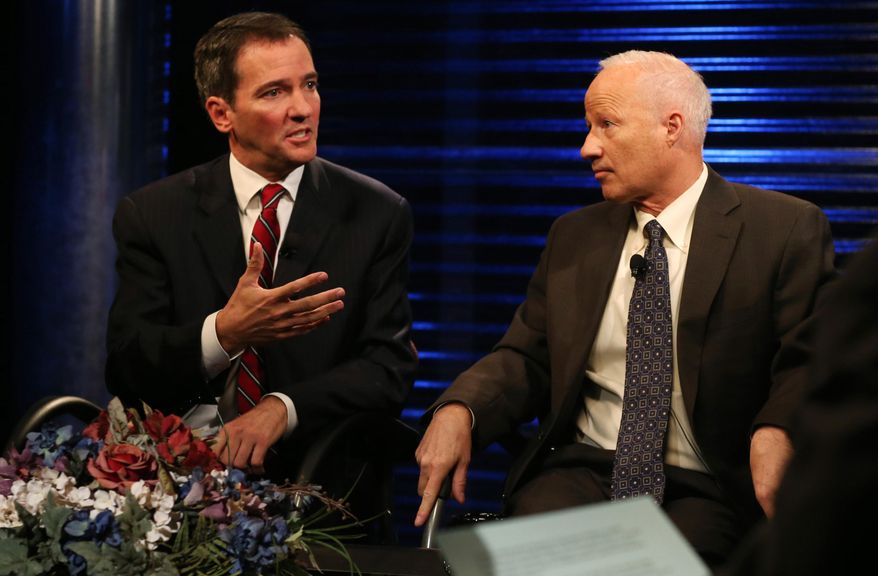 Democratic challenger Andrew Romanoff, left, makes point as his opponent, Republican incumbent Mike Coffman, looks on during taped debate in the race for the seat in Colorado's 6th Congressional District in the studios of Channel 12 in Denver on Thursday, Oct. 9, 2014. Romanoff and Coffman are vying for the seat in the most competitive House race. (AP Photo/David Zalubowski)