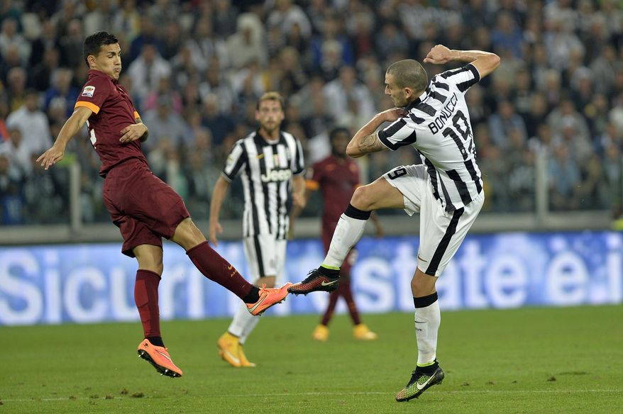 Juventus' Leonardo Bonucci scores during a Serie A soccer match between Juventus and Roma at the Juventus stadium, in Turin, Italy, Sunday, Oct. 5, 2014. Juventus beat Roma 3-2 in a fiery clash to take sole lead of the Serie A on Sunday as the capital side dropped its first points of the season. (AP Photo/Massimo Pinca)
