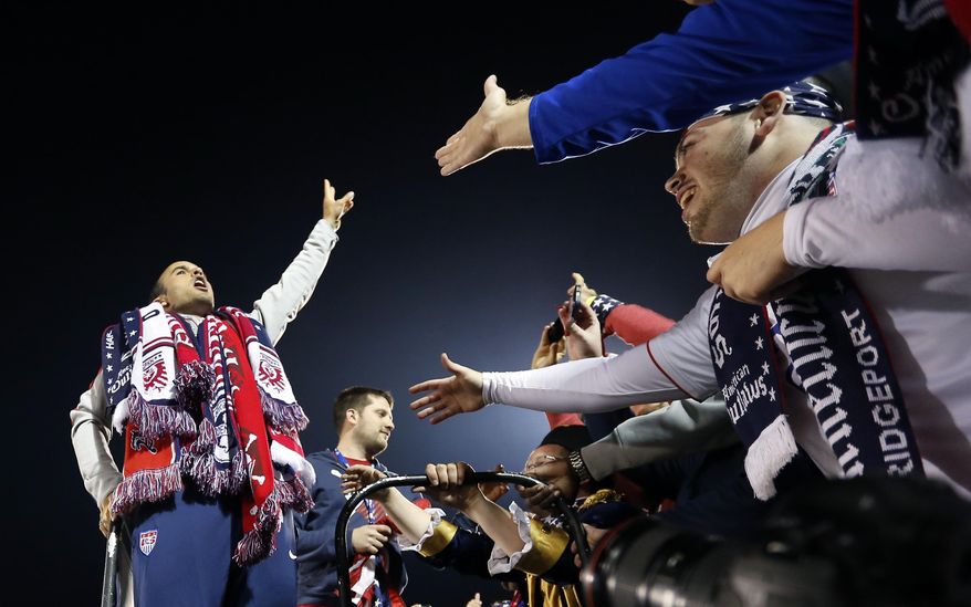 United States' Landon Donovan, left, celebrates with fans after an exhibition soccer match against Ecuador in East Hartford, Conn., Friday, Oct. 10, 2014. Donovan made his last international soccer appearance. (AP Photo/Elise Amendola)