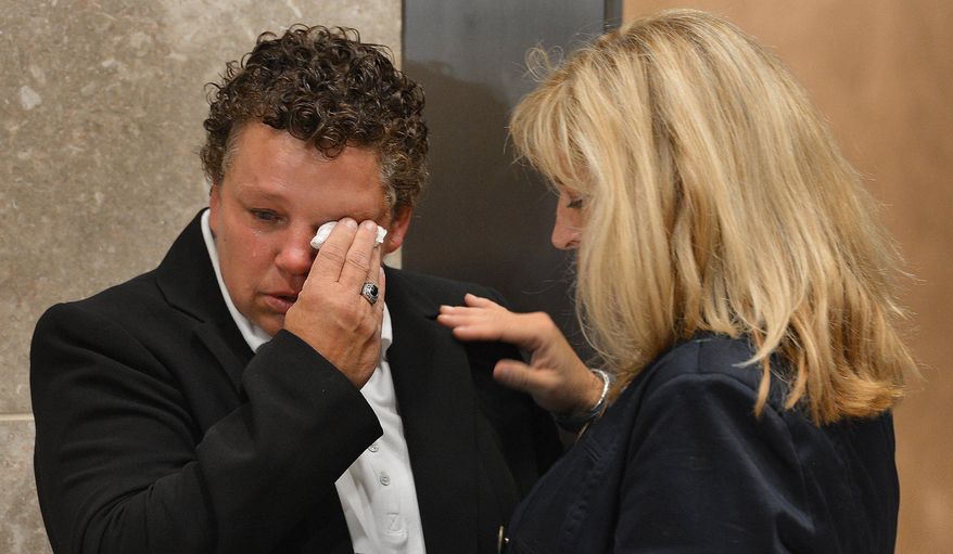 Vicki Britt wipes away tears as her partner, Trish Philbrook, comforts her during the announcement that there will be no marriages performed at the Wake County Courthouse in Raleigh, N.C. on Friday, Oct. 10, 2014. U.S. District Judge William Osteen signed an order late Friday afternoon that pushed to next week the decision on whether to nullify the definition of marriage in the North Carolina Constitution that restricts unions to a man and a woman. (AP Photo/The News & Observer, Chuck Liddy)