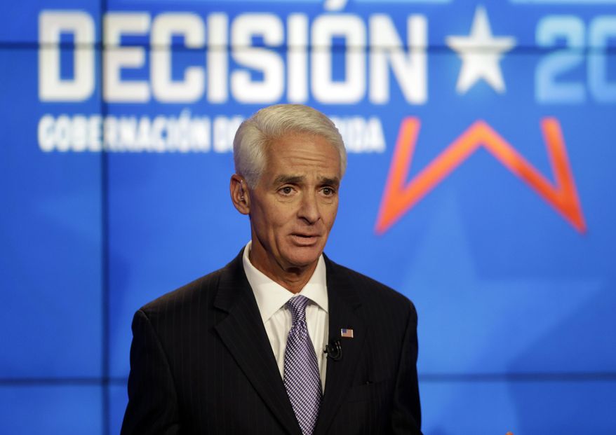 Democrat Charlie Crist, a former Republican governor of Florida, responds to a question during a gubernatorial debate against Florida Republican Gov. Rick Scott at the Spanish-language network Telemundo 51, Friday, Oct. 10, 2014, in Miramar, Fla.This is the first of three debates before the November election. (AP Photo/Lynne Sladky)