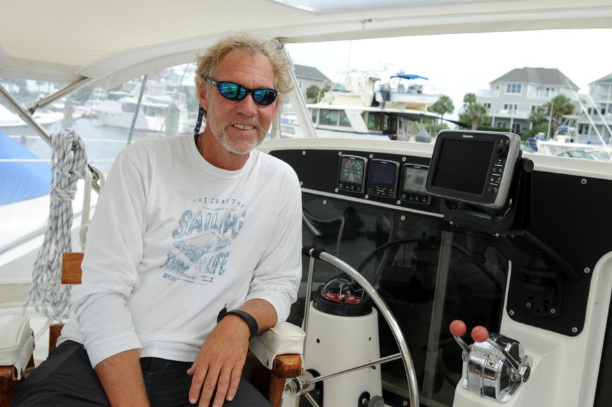 ADVANCE FOR USE MONDAY, OCT. 13 - In this photo taken on Sept. 16, 2014, David Lawn poses for a photo in his 42-foot catamaran the "Sea Angel" in Carolina Beach, N.C. Lawn will sail to the South Pacific as part of the non-profit Sea Mercy that provides free floating health care clinics. (AP Photo/The Star-News, Mike Spencer) LOCAL TELEVISION OUT; LOCAL INTERNET OUT
