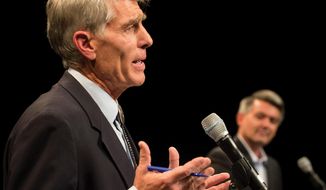Democrat Mark Udall, left, makes a point as Republican opponent Corey Gardner listens during their debate for the Colorado U.S. Senate at Memorial Hall on Thursday, Oct. 9, 2014 in Pueblo, Colo. (AP Photo, Chris McLean/The Pueblo Chieftain)