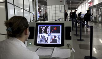 A health worker scans skin temperature of the passengers with a thermal imaging camera upon their arrival at Alexander the Great airport near Macedonia&#x27;s capital Skopje, Friday, Oct. 10, 2014. Macedonian health officials said Friday that there are small chances that the British traveler who had died Thursday in Skopje was infected by Ebola virus. (AP Photo/Boris Grdanoski)