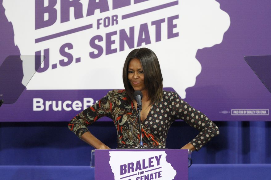 First Lady of the United States Michelle Obama speaks to the crowd at the Iowa Votes Rally on Friday, Oct. 10, 2014 at the Drake Fieldhouse in Des Moines. Obama was there to stump for U.S. Senate candidate Bruce Braley. (AP Photo/The Des Moines Register, Kelsey Kremer)
