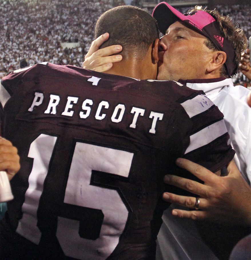 Mississippi State coach Dan Mullen kisses quarterback Dak Prescott after No. 3 Mississippi State defeated No. 2 Auburn 38-23 in an NCAA college football game in Starkville, Miss., Saturday, Oct. 11, 2014. (AP Photo/Jim Lytle)