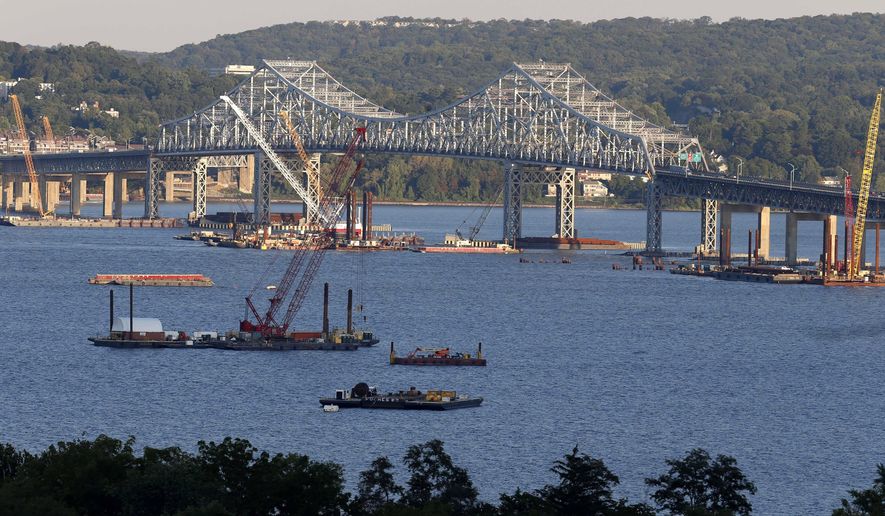 FILE--In this Sept. 18, 2014 file photo, construction equipment is positioned near the Tappan Zee Bridge as seen from Nyack, N.Y. New York Gov. Andrew Cuomo is running for a second term without having to face the political fallout from big decisions on fracking and new tolls on the Tappan Zee Bridge, because those politically charged decisions won’t be made until after Election Day.  (AP Photo/Seth Wenig, File)