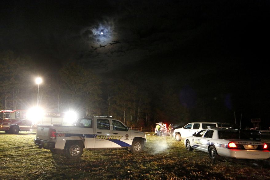 Emergency personnel work at the site of a hayride rollover that injured multiple people Harvest Hill Farms in Mechanic Falls on Route 126, Saturday, Oct. 11, 2014. Police in Maine confirm a teen has died and two remain in critical condition after the crash crashed. At least 20 other passengers were taken to area hospitals for treatment. (AP Photo/Maine Today, Gabe Souza) NO SALES