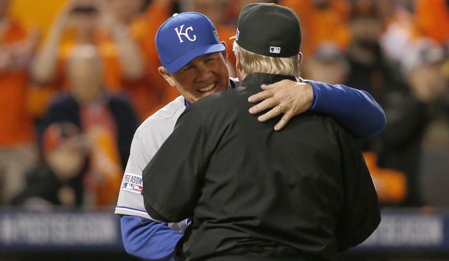 Kansas City Royals manager Ned Yost greets Baltimore Orioles manager Buck Showalter before the start of Game 1 of the American League baseball championship series Friday, Oct. 10, 2014, in Baltimore. (AP Photo/Alex Brandon) 