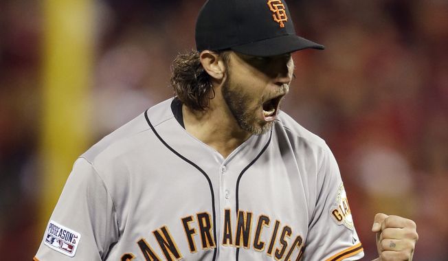 San Francisco Giants starting pitcher Madison Bumgarner reacts after striking out St. Louis Cardinals&#x27; Tony Cruz during the seventh inning in Game 1 of the National League baseball championship series Saturday, Oct. 11, 2014, in St. Louis. (AP Photo/Jeff Roberson) 