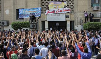 Student protesters hold a rally at Cairo University in Cairo, Egypt, Sunday, Oct. 12, 2014. Security officials said police backed by armored vehicles have stormed the campuses of at least two prominent Egyptian universities to quell anti-government protests by students. Sunday&#39;s largest rallies took place at Cairo and the Islamist al-Azhar universities. They were organized by supporters of ousted Islamist President Mohammed Morsi. (AP Photo/El Shorouk, Aly Hazzaa) EGYPT OUT