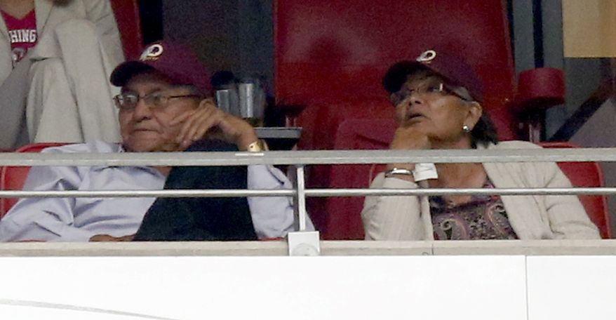 Navajo Nation president Ben Shelly and First Lady Martha Shelly wear Washington Redskins caps during the second half of an NFL football game against the Arizona Cardinals in Redskins owner Daniel Snyders&#x27; suite, Sunday, Oct. 12, 2014, in Glendale, Ariz.(AP Photo/Ross D. Franklin) 
