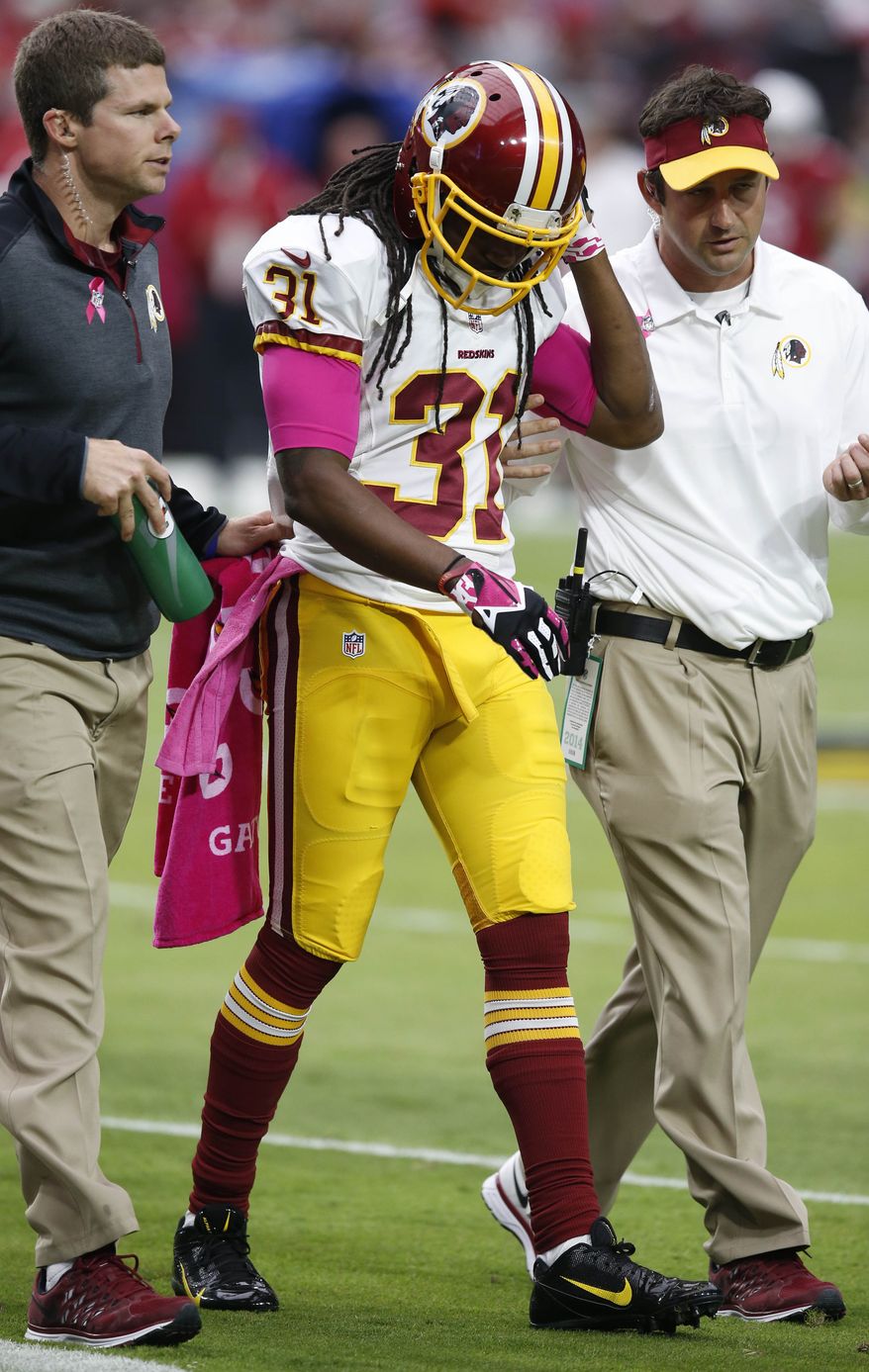 Washington Redskins strong safety Brandon Meriweather leaves the field after being injured against the Arizona Cardinals during the first half of an NFL football game, Sunday, Oct. 12, 2014, in Glendale, Ariz.(AP Photo/Ross D. Franklin) 
