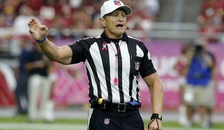 Referee Ed Hochuli (85) makes a call during the first half of an NFL football game between the Arizona Cardinals and the Washington Redskins, Sunday, Oct. 12, 2014, in Glendale, Ariz.(AP Photo/Rick Scuteri) 
