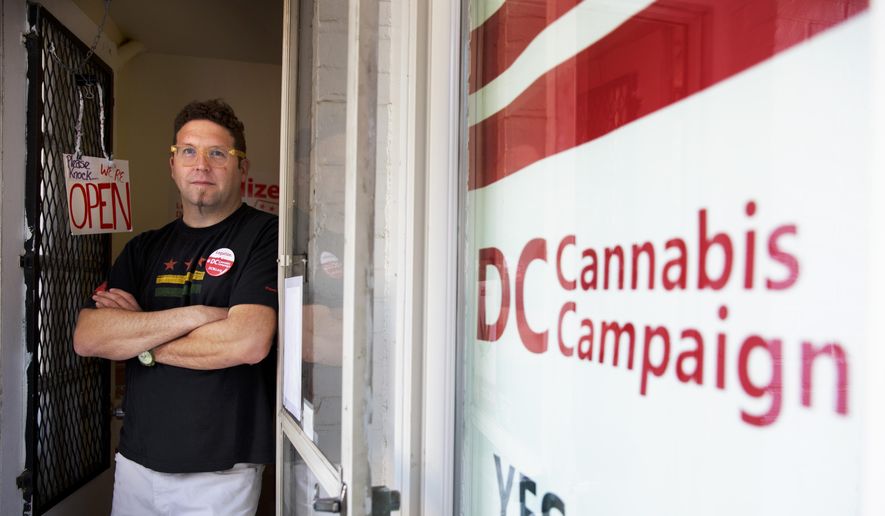 In this photo taken Oct. 9, 2014, Adam Eidinger, chairman of the DC Cannabis Campaign, poses for a portrait at the DC Cannabis Campaign headquarters, where he works in support of DC Ballot Initiative 71 to legalize small amounts of marijuana for personal use, in Washington. Legalized weed would look far different in the nation&#39;s capital than it does in other places that have chosen to decriminalize marijuana. Even if voters approve it next month, as appears likely, it would remain banned in the roughly one-fourth of the District of Columbia that is federal land, so there would still be no lighting a joint in front of the Jefferson Memorial. The capital also remains under the thumb of Congress, which could quash legalization in D.C. regardless of what the voters want. (AP Photo/Jacquelyn Martin) 