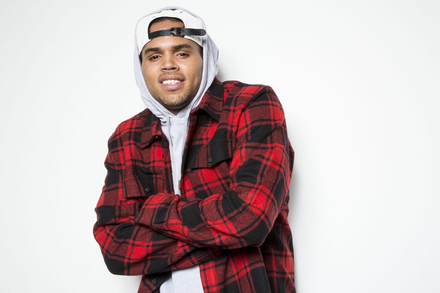 FILE - In this Sept. 17, 2014 file photo, singer Chris Brown poses for a portrait in Los Angeles. Brown racked up 7 nominations, including Best R&amp;amp;B/Soul Male Artist, Song of the Year for “Loyal.” Beyonce earned six nominations and Pharrell Williams followed with five. Hosted by Wendy Williams, the Soul Train Awards will be presented on Nov. 7 in Las Vegas. The awards will air on Nov. 30 on Centric and BET. (Photo by Omar Vega/Invision/AP, File)