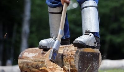 Chris Minore, of Orange, Conn., performs the under chop technique at the Adirondack Woodsmen&#39;s School at Paul Smith&#39;s College in Paul Smiths, N.Y., on July 10, 2014. (Associated Press) **FILE**