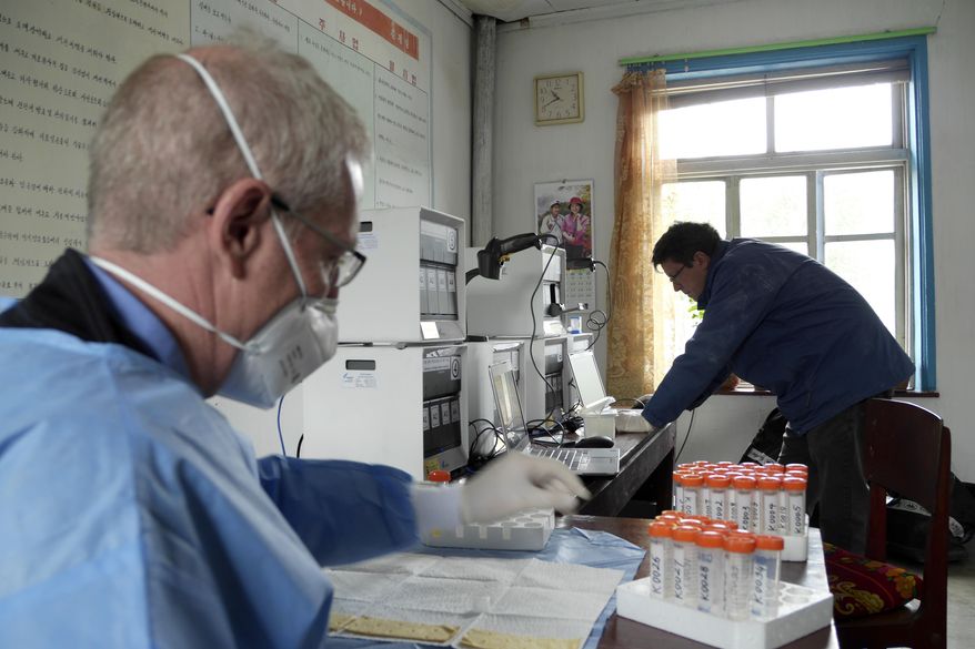 This undated handout provided by the Eugene Bell Foundation (EBF) shows John Rogers, executive director of the Eugene Bell Foundation, left, and a and EBF volunteer analyze test results for tuberculosis patients in a TB treatment center in Sonchon, North Korea. Despite worsening U.S.-North Korean relations, an American charity is ramping up efforts against an epidemic of multidrug-resistant tuberculosis in the isolated country, where it says it is making inroads in fighting the deadly disease. The Eugene Bell Foundation travels to North Korea twice-a-year, bringing high-end equipment and drugs to treat patients at old-world sanatoria that house sufferers of TB that has spread among a population weakened by malnutrition since a famine in the 1990s. The foundation goes again this month, on a whirlwind, three-week mission to help hundreds of patients.(AP Photo/Eugene Bell Foundation) **FILE**
