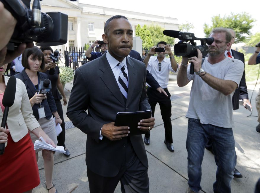 FILE - In this Tuesday, June 3, 2014, file photo, former Charlotte Mayor Patrick Cannon, center, walks past the media as he leaves the federal courthouse in Charlotte, N.C. Cannon is scheduled to be sentenced, Tuesday, Oct. 14, 2014, in a federal corruption case, in Charlotte, N.C. (AP Photo/Chuck Burton, File)