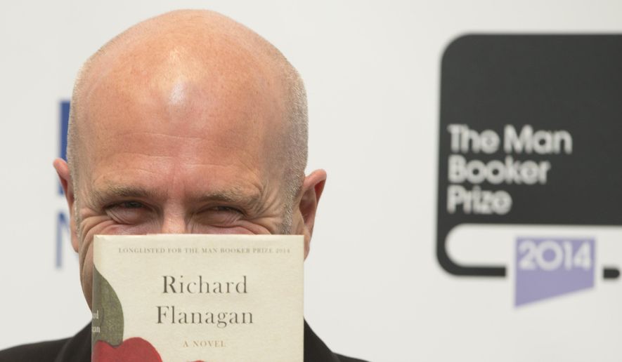 Winner of the Man Booker for fiction 2014 Australian author Richard Flanagan, author of 'The Narrow Road to the Deep North', poses for the camera after winning the prize at the Guildhall in London, Tuesday, Oct. 14, 2014. (AP Photo/Alastair Grant)