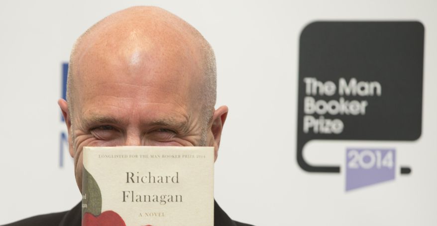 Winner of the Man Booker for fiction 2014 Australian author Richard Flanagan, author of 'The Narrow Road to the Deep North', poses for the camera after winning the prize at the Guildhall in London, Tuesday, Oct. 14, 2014. (AP Photo/Alastair Grant)
