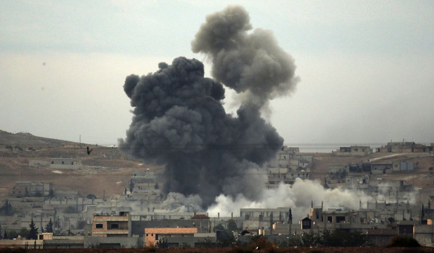 Thick smoke rises following an airstrike by the US-led coalition in Kobani, Syria while fighting continued between Syrian Kurds and the militants of Islamic State group, as seen from Mursitpinar on the outskirts of Suruc, at the Turkey-Syria border, Tuesday, Oct. 14, 2014. Kobani, also known as Ayn Arab, and its surrounding areas, has been under assault by extremists of the Islamic State group since mid-September and is being defended by Kurdish fighters. (AP Photo/Lefteris Pitarakis)