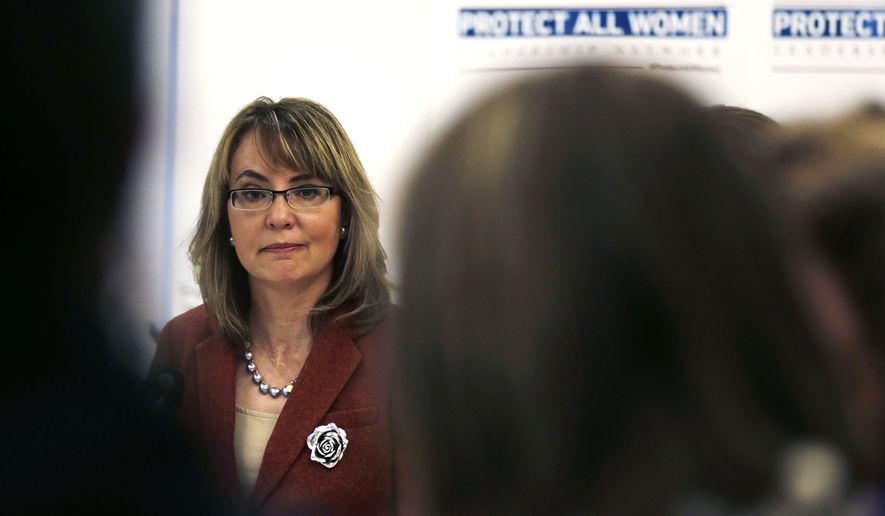 Former Arizona Rep. Gabby Giffords listens to a speaker during a roundtable discussion on the first stop of her &quot;Protect All Women&quot; tour in Portland, Maine, Tuesday, Oct. 14, 2014.  Giffords, who was severely wounded in a 2011 shooting that killed six in Tucson, is seeking to elevate the issue of gun violence against women on state and federal levels. (AP Photo/Charles Krupa)