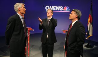Incumbent U.S. Sen. Mark Udall, D-Colo., left, and his opponent U.S. Rep. Cory Gardner, R-Colo., right, watch as 9NEWS KUSA-TV political reporter Brandon Rittiman flips a coin to determine who gets the first question, before the start of a televised debate at 9News in Denver, Wednesday Oct. 15, 2014. (AP Photo/Brennan Linsley)