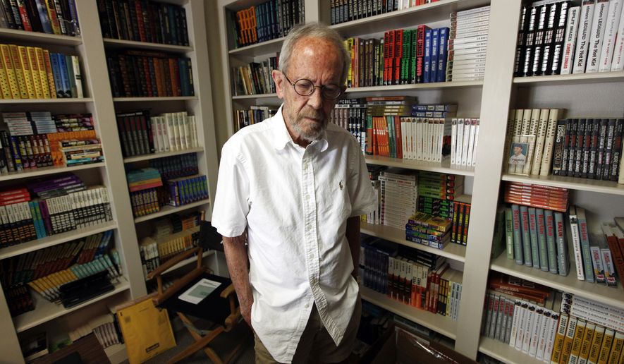 FILE - In this Sept. 17, 2012 file photo, author Elmore Leonard, 86, stands in his Bloomfield Township, Mich., home. Choice samples from a vast collection of handwritten notebooks, typed manuscripts and screenplays by the late best-selling crime novelist Elmore Leonard are going on display at the University of South Carolina. Leonard, a former adman who later in life became one of America's foremost crime writers, has died on Aug. 20, 2013 from complications from a stroke. (AP Photo/Paul Sancya)