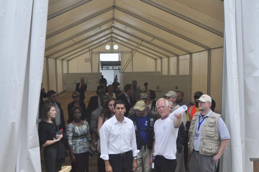 Rajiv Shah (center), serving as administrator of the U.S. Agency for International Development, inspected a newly built treatment center in Monrovia, Liberia, during the devastating 2014 outbreak. A task force organized by the Center for Strategic and International Studies recommended preserving USAID as an independent agency coordinating all U.S. foreign assistance and not folding it into the State Department. (Associated Press/File)