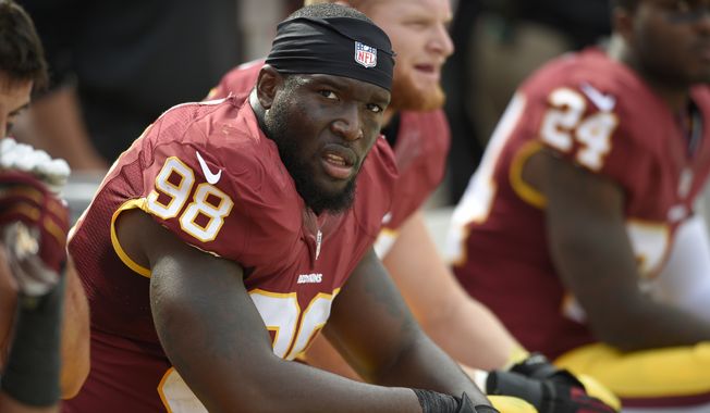 Washington Redskins outside linebacker Brian Orakpo (98) looks on from the bench during the second half of an NFL football game against the Jacksonville Jaguars, Sunday, Sept. 14, 2014, in Landover, Md. The Redskins won 41-10. (AP Photo/Nick Wass) **FILE**