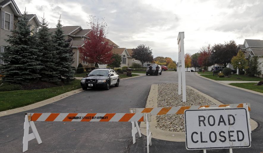 Tallmadge police cordon off a home in Tallmadge, Ohio, Wednesday, Oct. 15, 2014, where Amber Joy Vinson stayed over the weekend before flying home to Dallas. Vinson, a nurse who helped care for Thomas Eric Duncan, has also been diagnosed with the Ebola virus. (AP Photo/Mark Duncan)