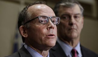 Dr. Dan Varga, chief clinical officer at Texas Health Presbyterian Hospital, speaks as Dallas Mayor Mike Rawlings looks on at right during a news conference, Wednesday, Oct. 15, 2014, in Dallas. A second health care worker has tested positive for Ebola. (AP Photo/LM Otero)