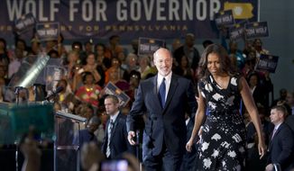First lady Michelle Obama campaigns for Pennsylvania Democratic gubernatorial candidate Tom Wolf Wednesday, Oct. 15, 2014, at the Dorothy Emanuel Recreation Center in Philadelphia. (AP Photo/Matt Rourke)