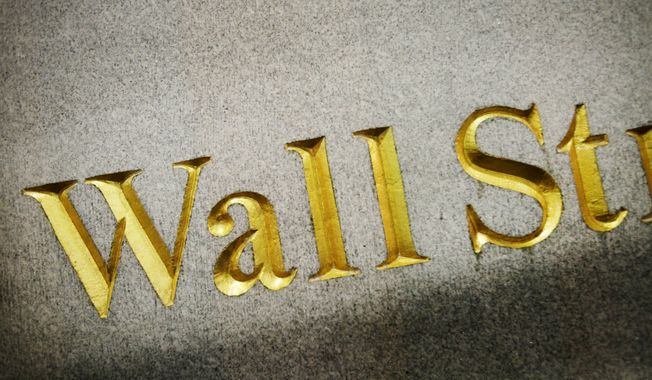 A Wall Street address is carved in the side of a building, Wednesday, Oct. 8, 2014 in New York. European stocks wallowed Wednesday Oct. 15, 2014 on dour growth prospects while Asian shares were mostly higher as a slump in energy prices promised benefits for the region&#x27;s major economies.  (AP Photo/Mark Lennihan)