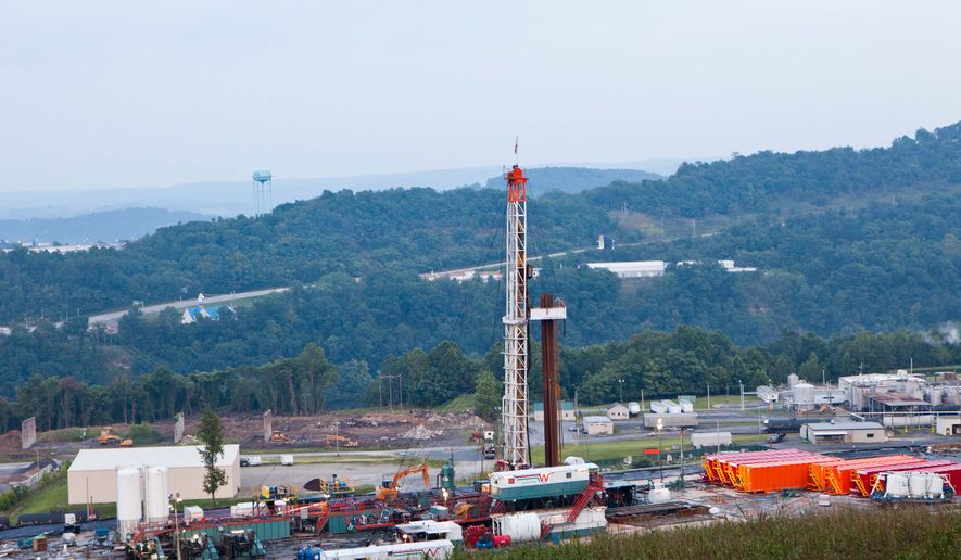 FILE - In this Aug. 6, 2011 file photo, a natural gas well operated by Northeast Natural Energy is seen in Morgantown, W.Va. Cheap and plentiful natural gas isn&amp;#8217;t quite a bridge to a brighter energy future as claimed and won&amp;#8217;t slow global warming, a new study projects. Abundant natural gas in the United States has been displacing coal, which produces more of the chief global warming gas carbon dioxide. But the new international study says an expansion of natural gas use by 2050 would also keep other energy-producing technologies like wind, solar and nuclear, from being used more. And those technologies are even better than natural gas for avoiding global warming. (AP Photo/David Smith)